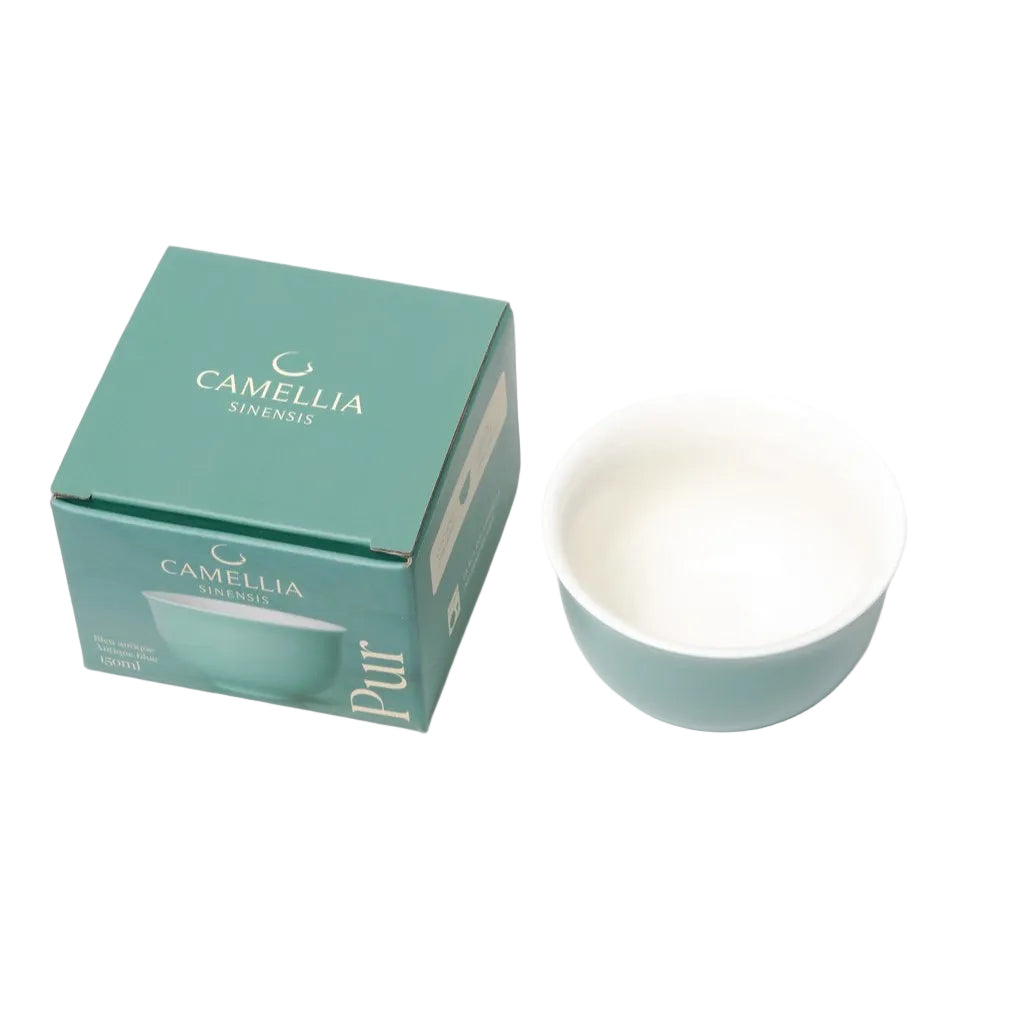 Teal ceramic bowl and packaging with 'Camellia Sinensis' branding on a white background