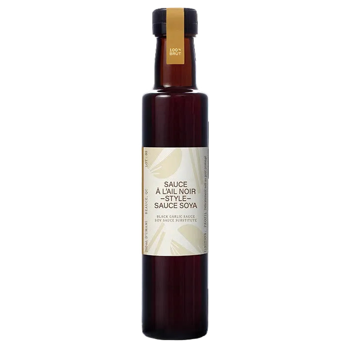 Bottle of black garlic sauce with a white label on a white background
